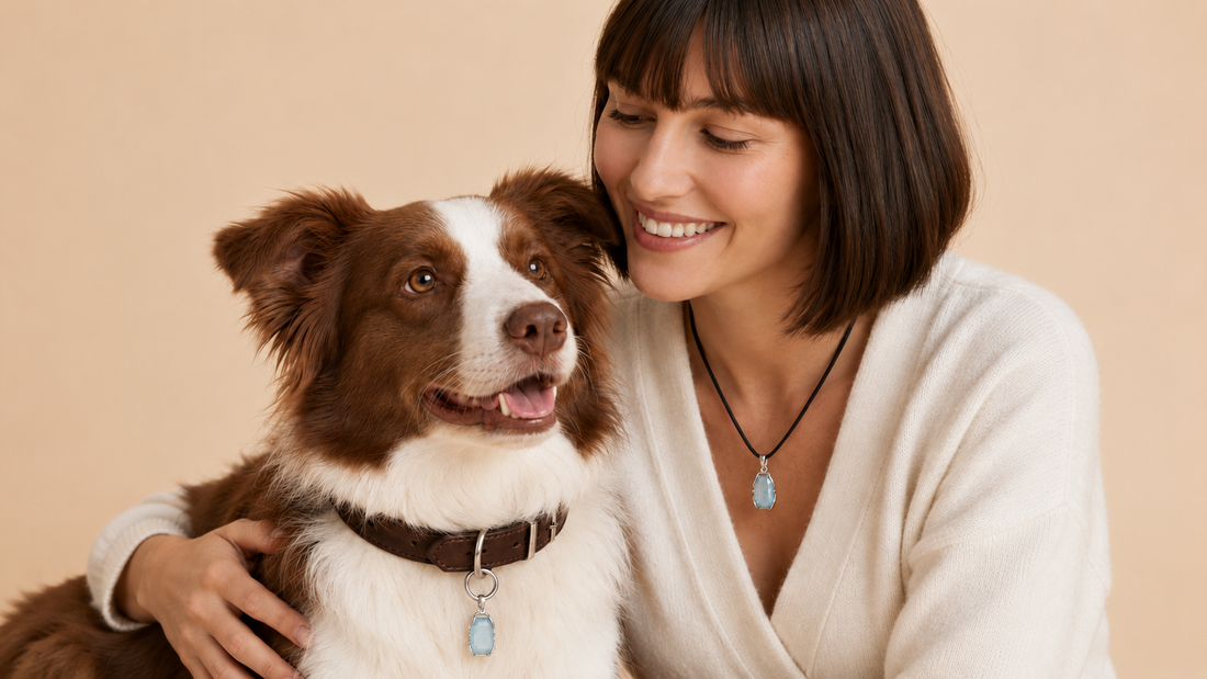 Woman and dog wearing matching aquamarine necklace and collar charm outdoors