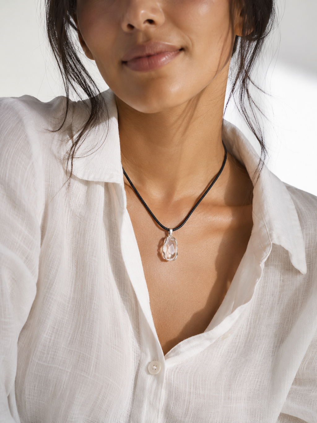 Woman wearing the VeilBond True Reflection clear quartz necklace
