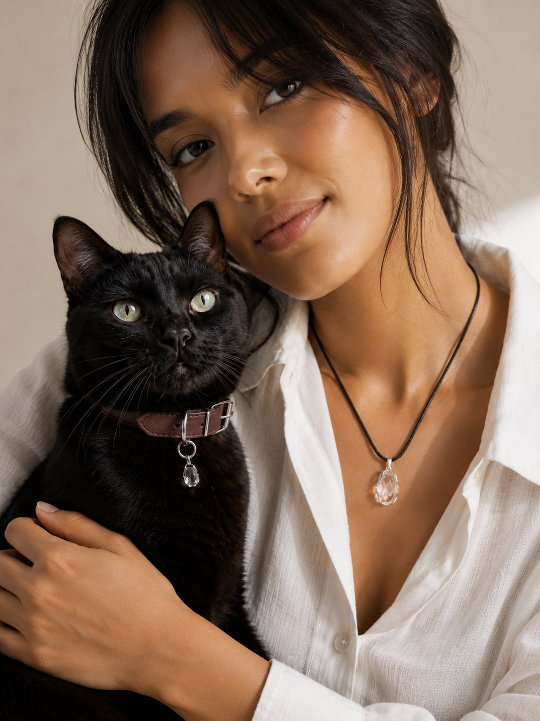 Woman and cat wearing matching VeilBond clear quartz pieces